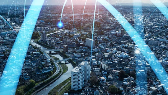 Aerial view over a city, as energy arcs from point to point, connecting the landscape